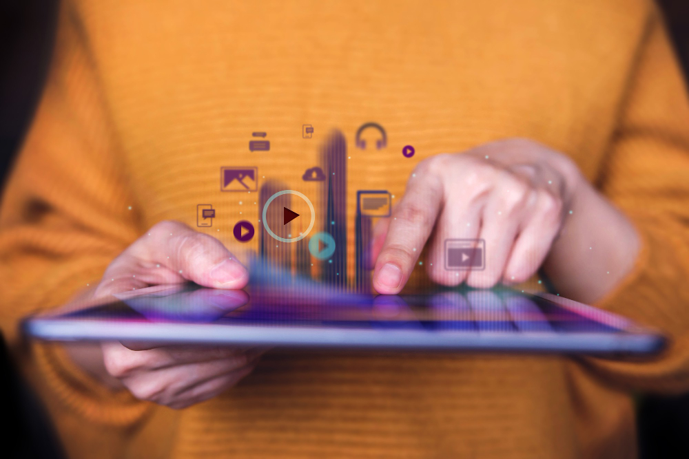 Image of person holding ipad to depict digital media. 