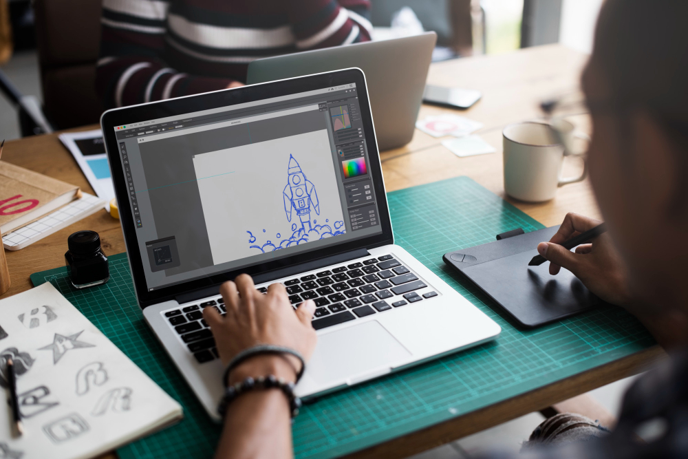 Image of student designing game on laptop. 