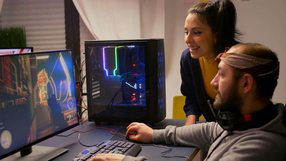 Image of man and woman in front of Gaming computer