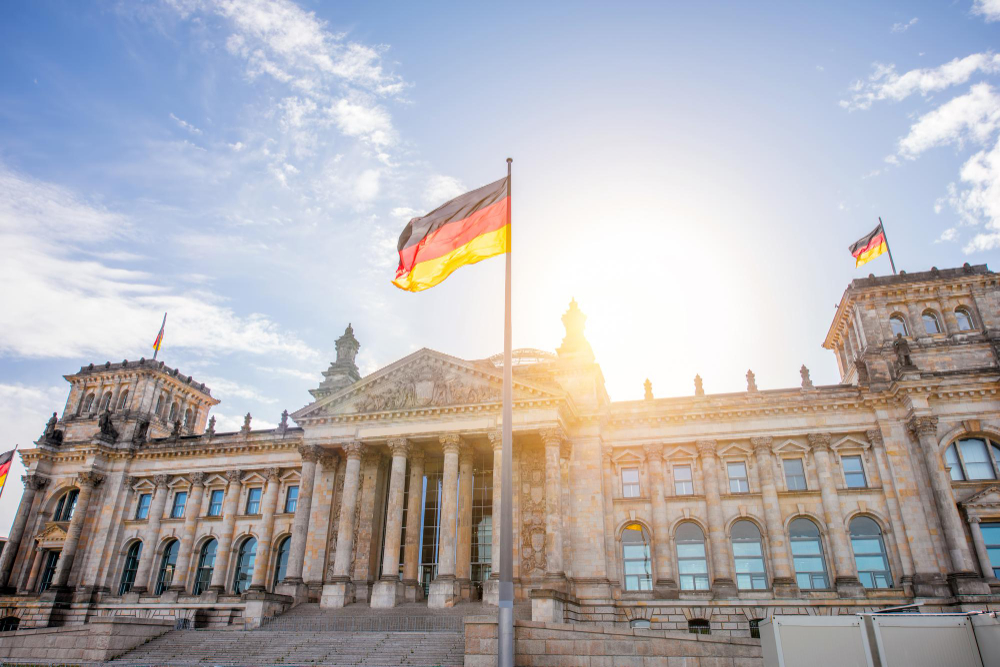 Image of flag in front of  Reichtag parliament in Germany. 