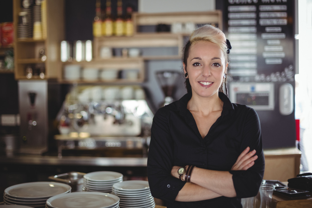 Image of woman in front of restaurant bar.