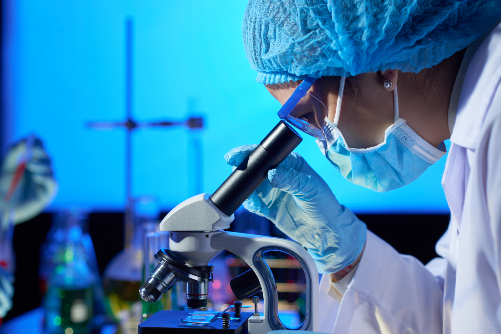 Image of scientist looking through a Microscope. 