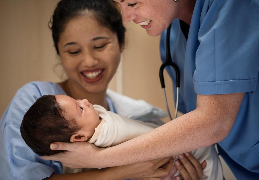 Image of a midwife student nurse scrubs with newborn babyn the background.