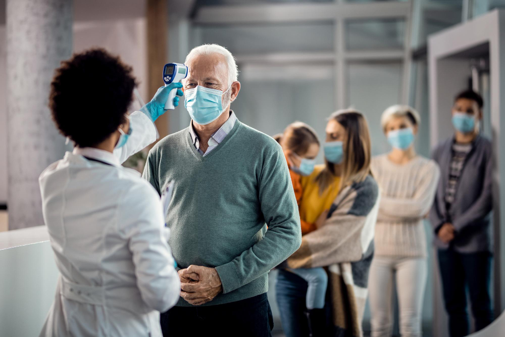 Image of patients getting their temperature checked. 