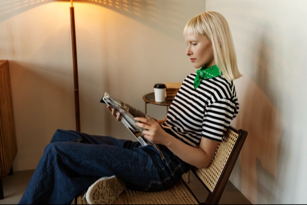 Image of Woman reading magazine